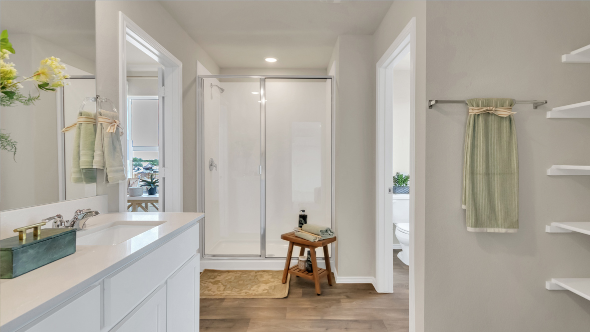Main bathroom with double vanity sink and walk-in shower.