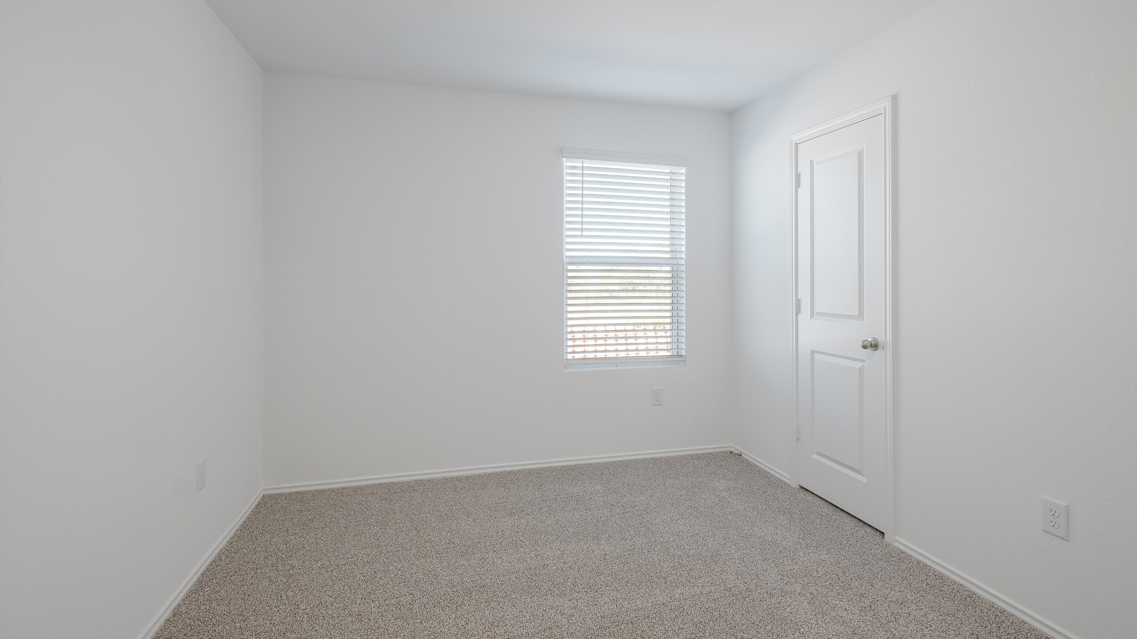 Bedroom 3 with carpeted floors.