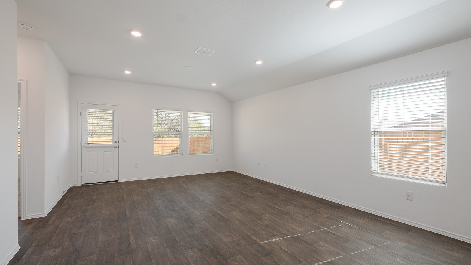 Open-concept living room with windows.