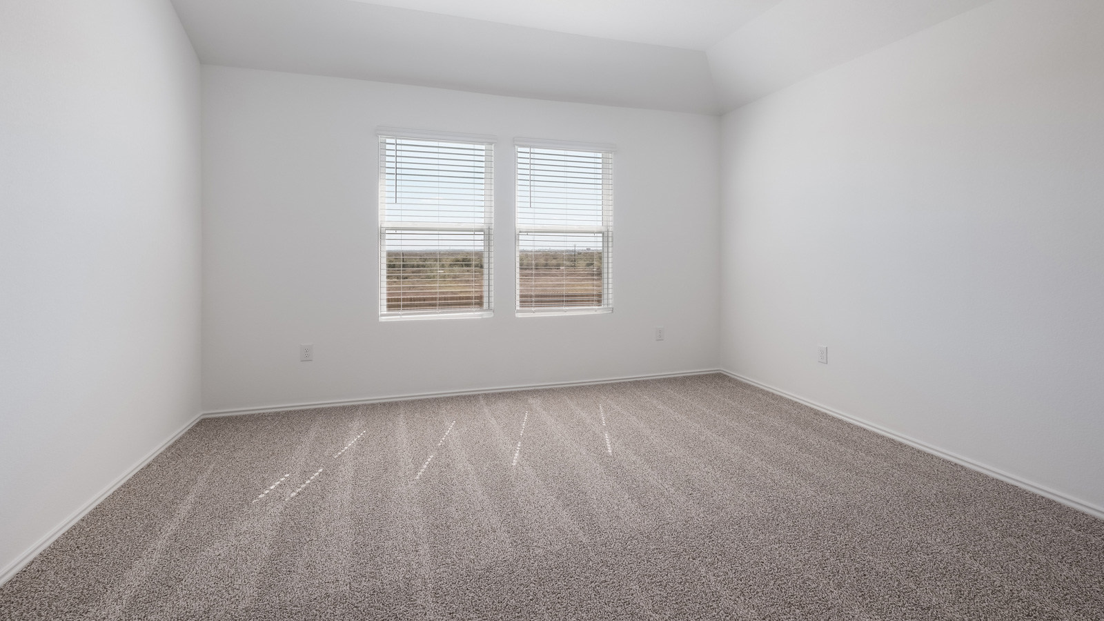 Bedroom 1 with carpeted floors and adjoined bathroom.