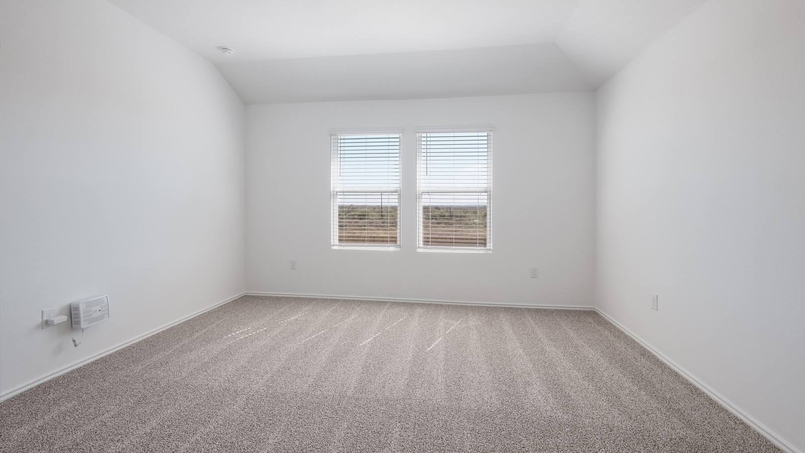 Bedroom 1 with carpeted floors and adjoined bathroom.