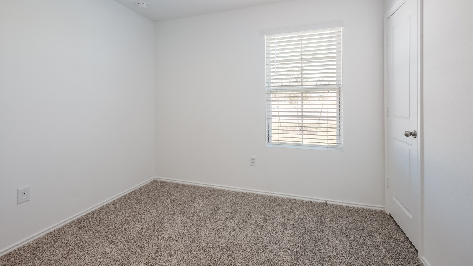 Bedroom 2 with carpeted floors and closet.
