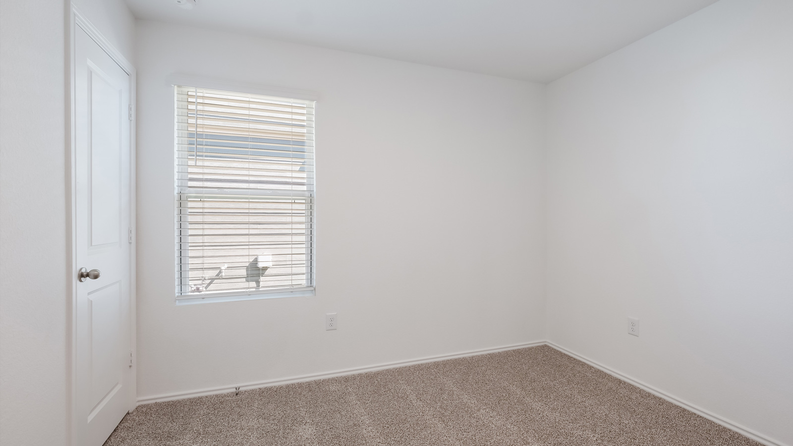 Bedroom 3 with carpeted floors and closet.