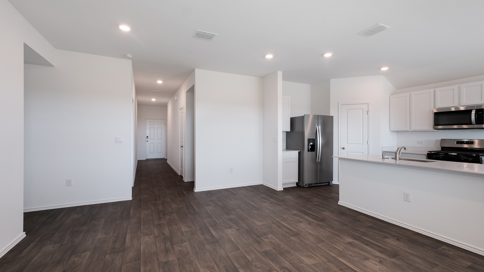 Kitchen with stainless steel appliances and quartz countertops.