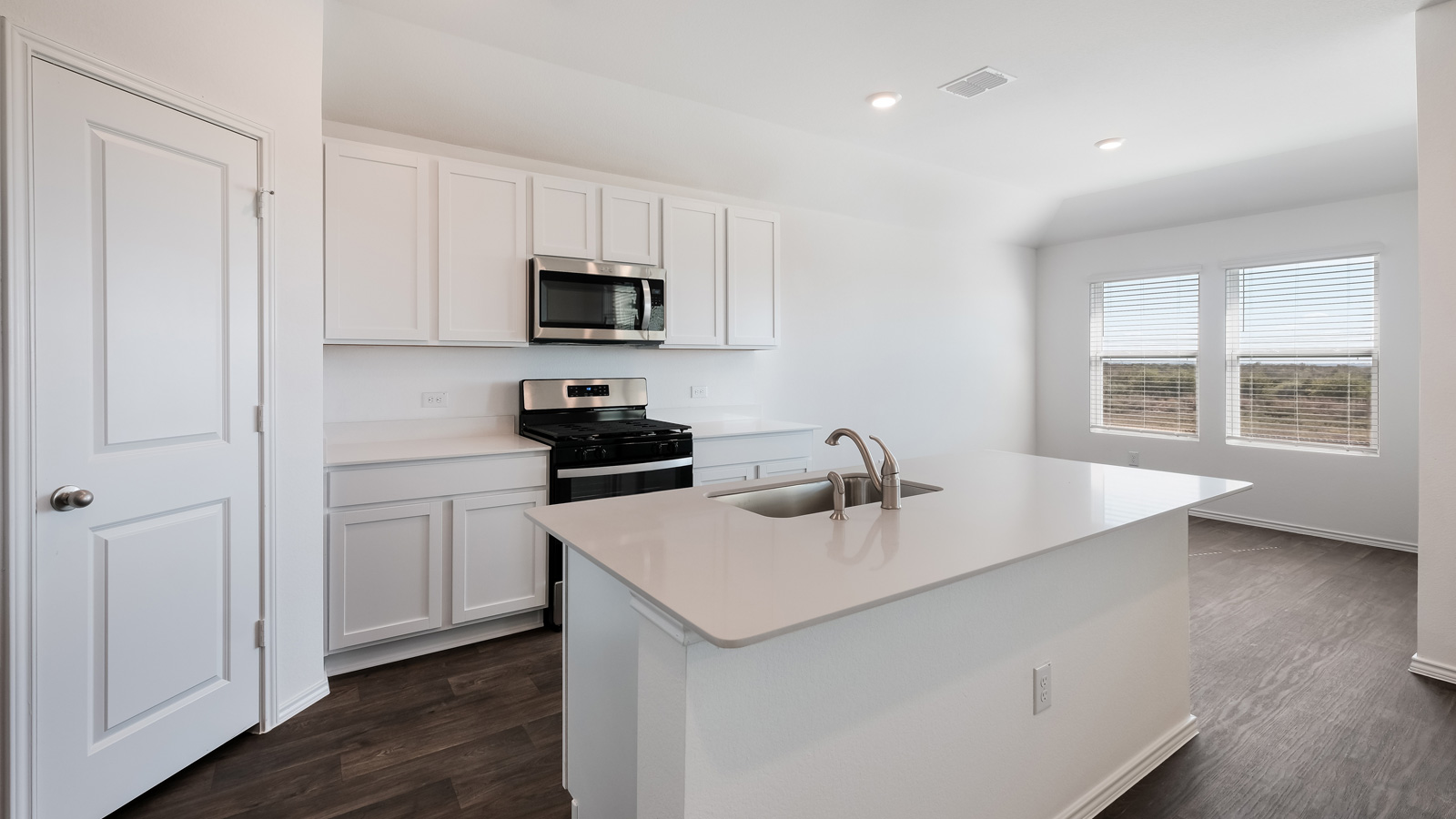 Kitchen with stainless steel appliances and quartz countertops.