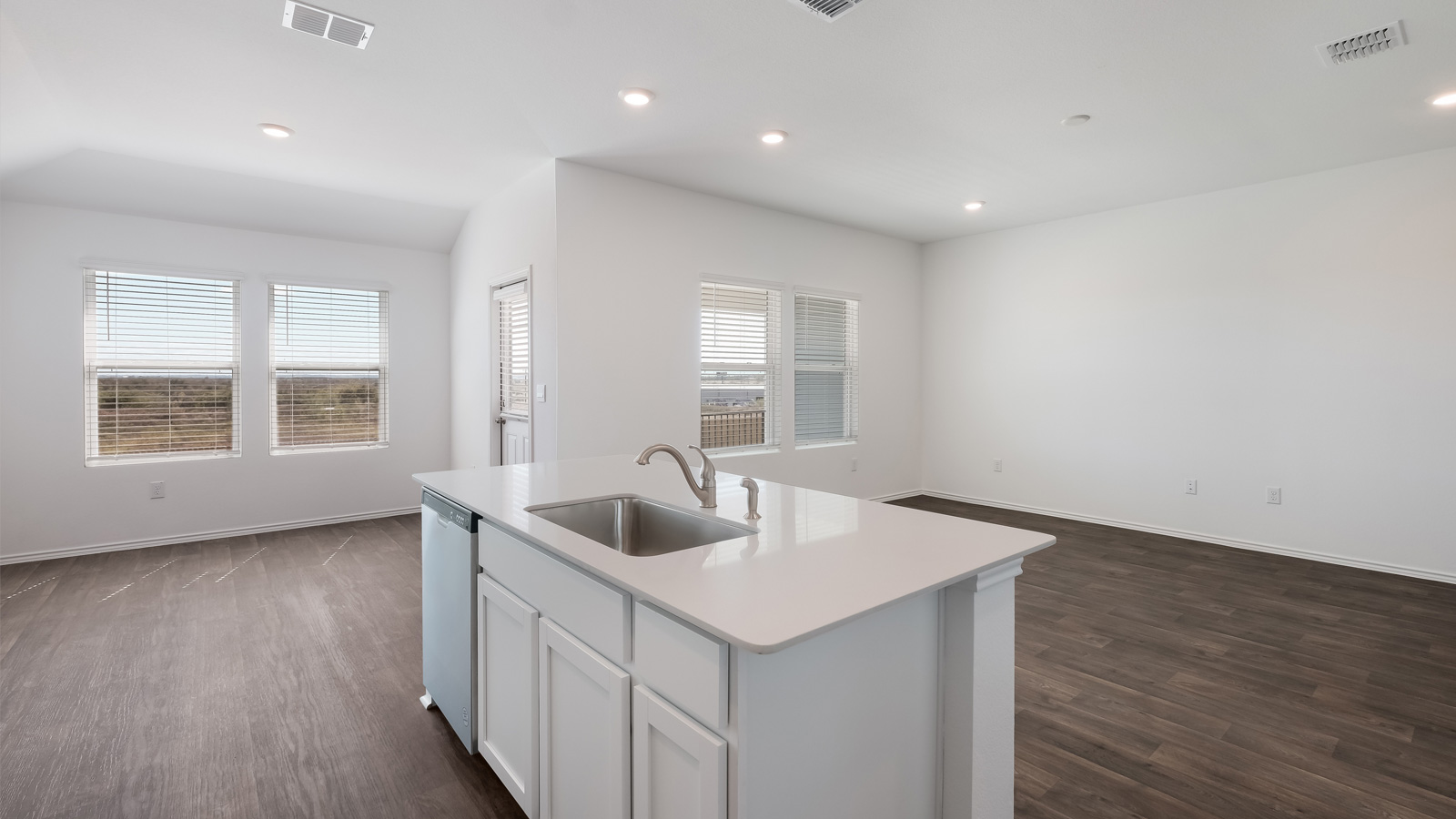 Kitchen with stainless steel appliances and quartz countertops.