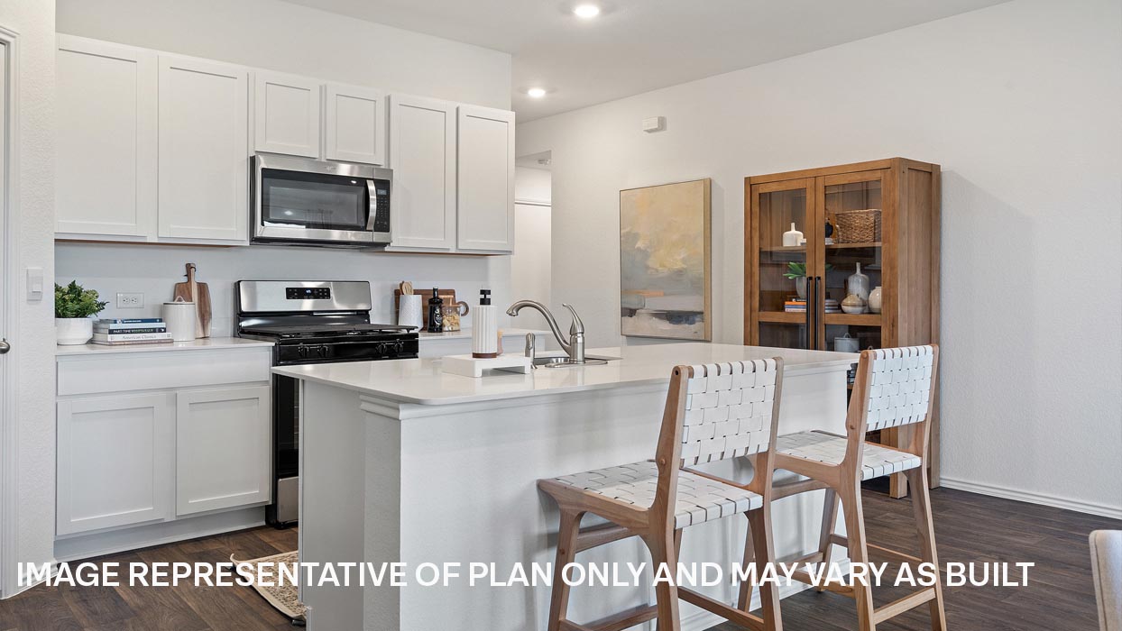 Modern kitchen with stainless steel range, microwave, and dishwasher.