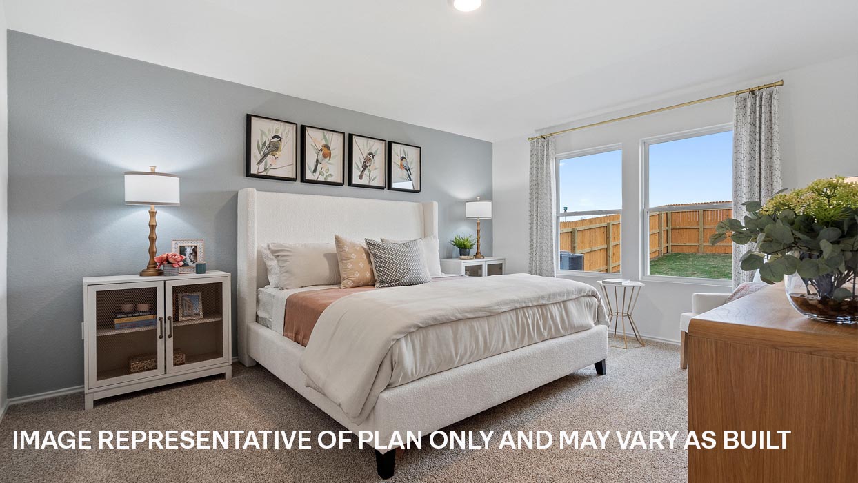 Primary bedroom with carpeted flooring and two windows.
