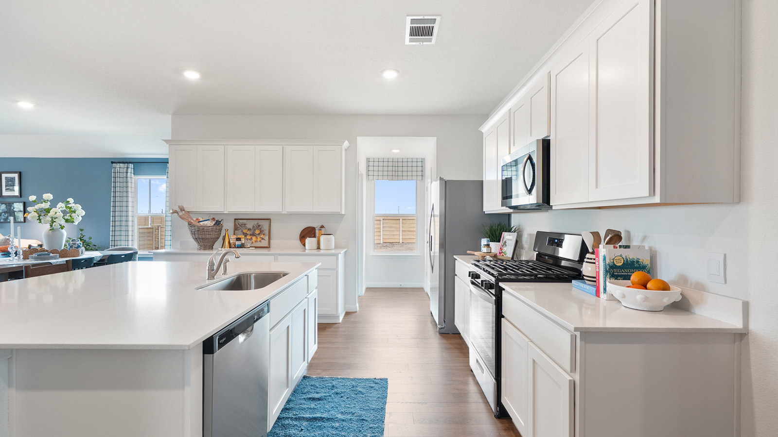 Interior kitchen with center island and white cabinets
