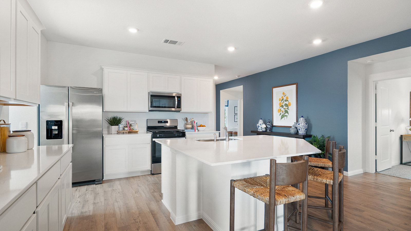 Interior kitchen with center island and white cabinets