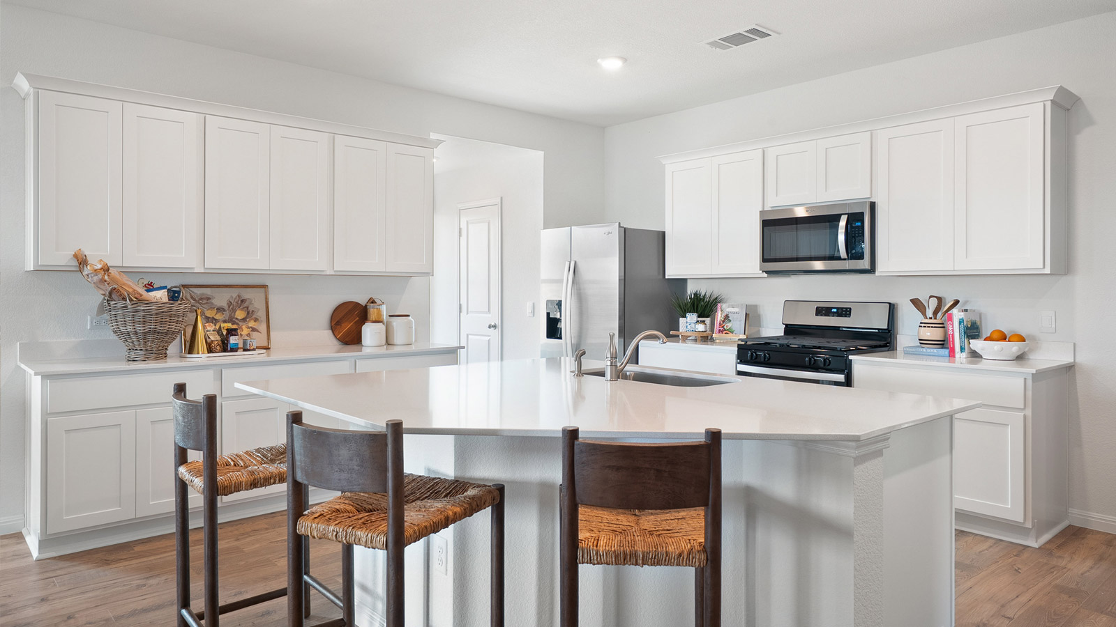 Interior kitchen with center island and white cabinets