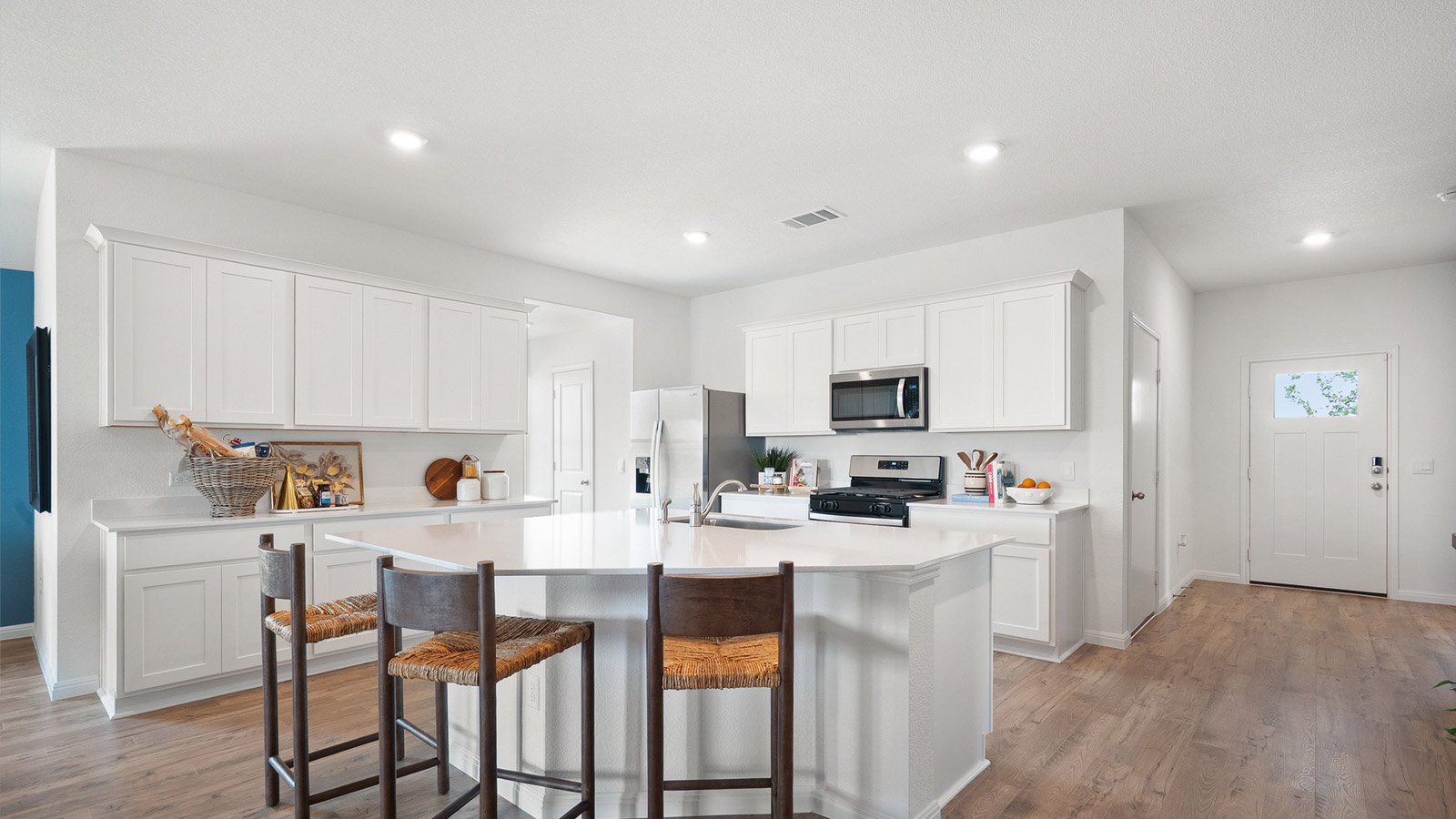 Interior kitchen with center island and white cabinets