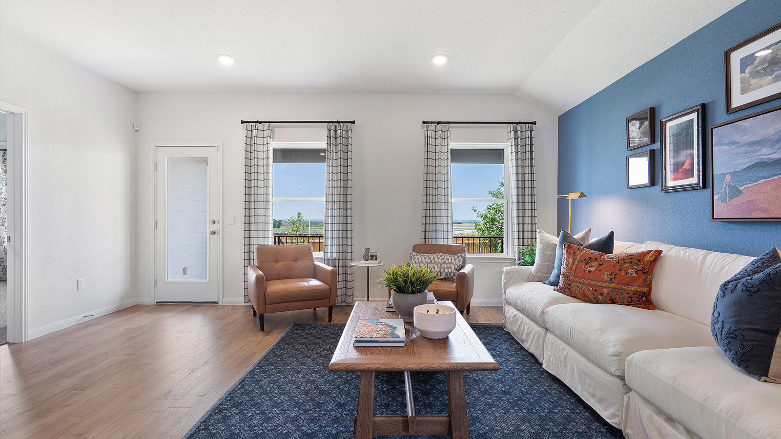 Interior living area with accent wall and windows