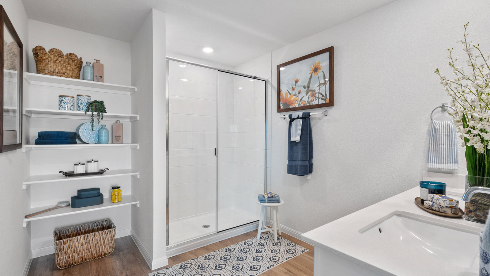 Interior bathroom with shower, shelving, and sink