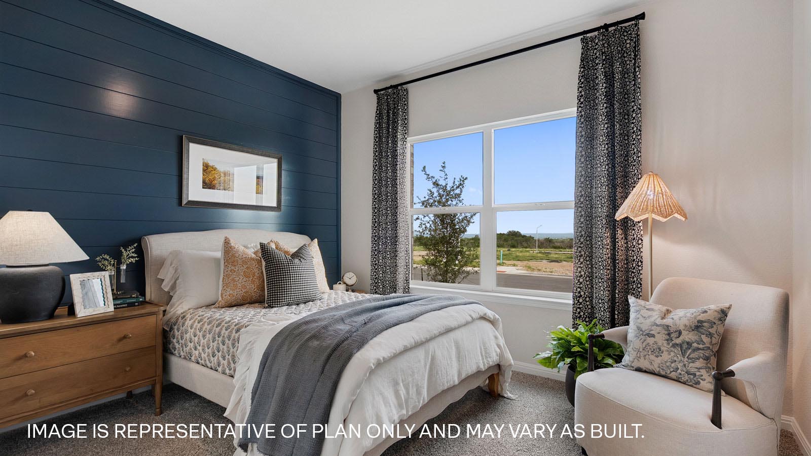 Secondary bedroom with carpeted flooring.