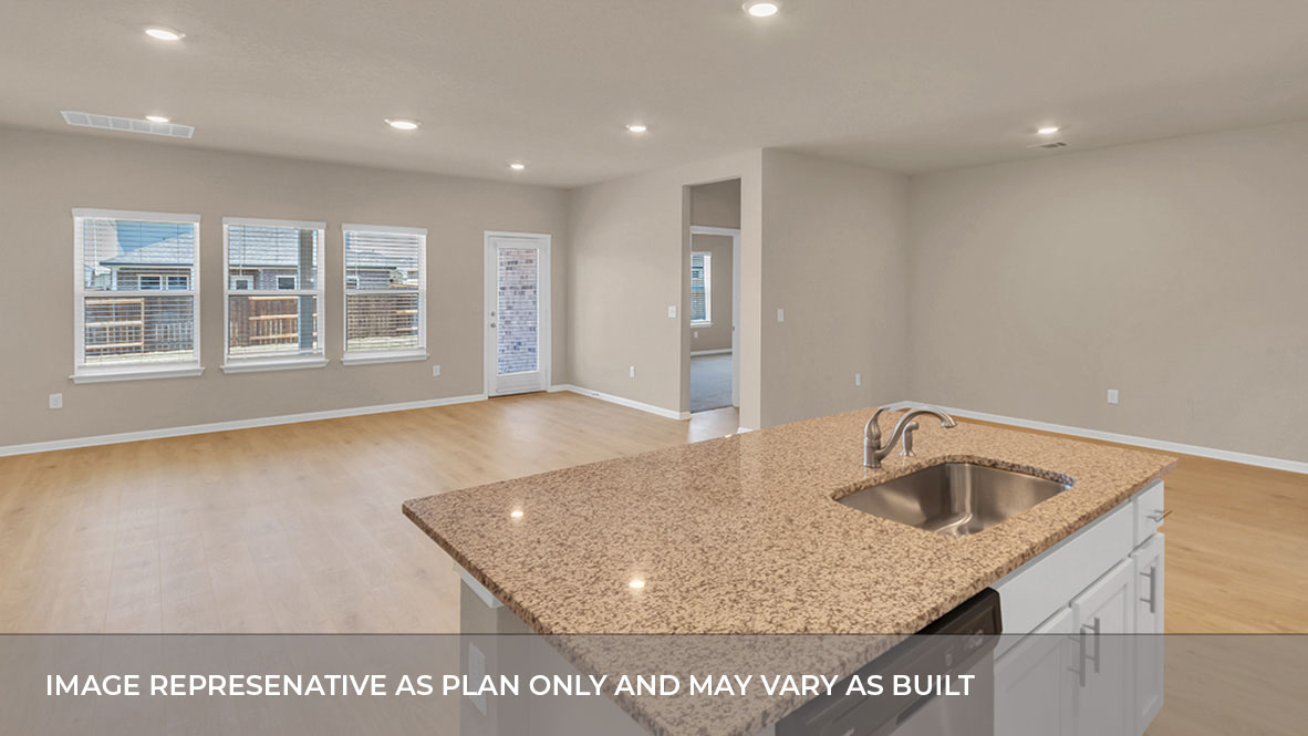 Interior kitchen open to living area with large windows