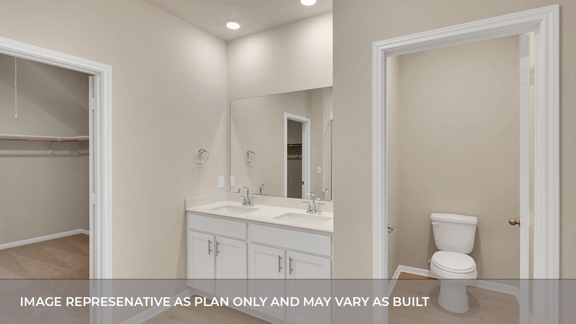Interior primary bathroom with double sink and walk-in closet