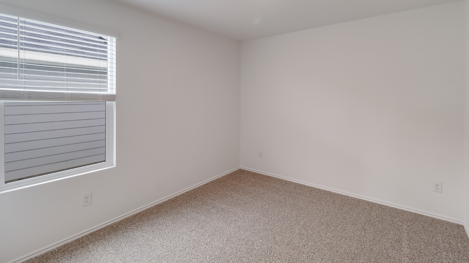 Bedroom 2 with carpeted flooring.