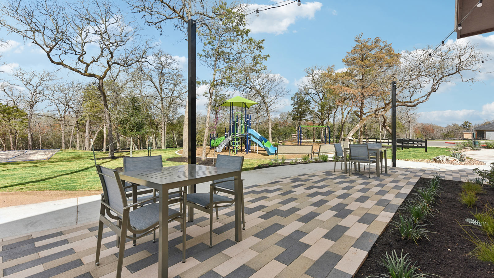 Patio with tables and chairs at Valverde amenity center.