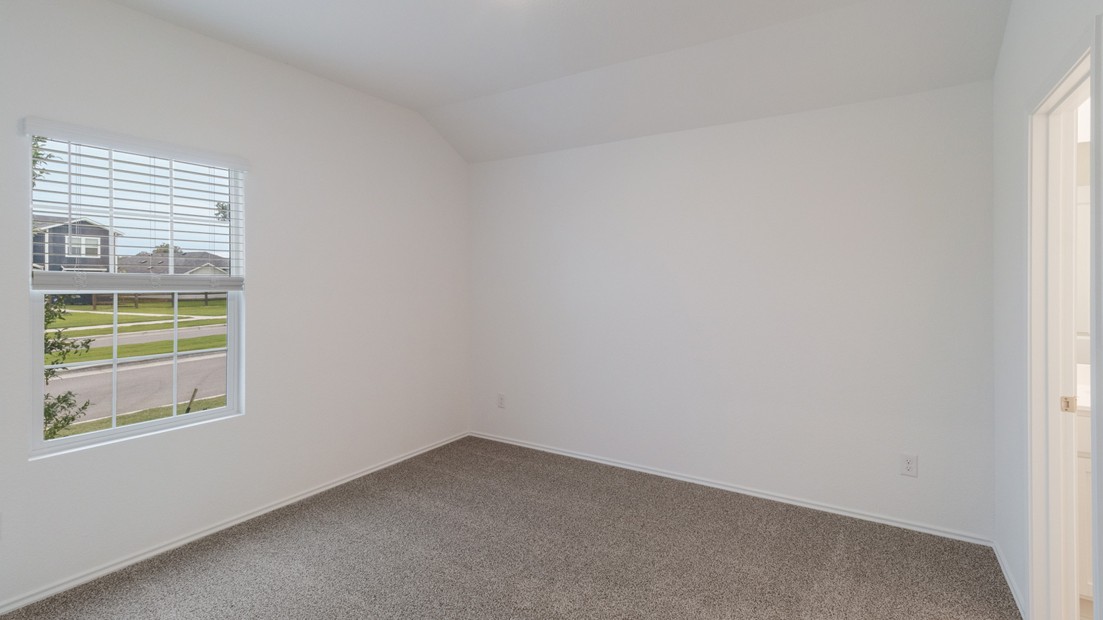 Main bedroom with carpeted flooring and window,