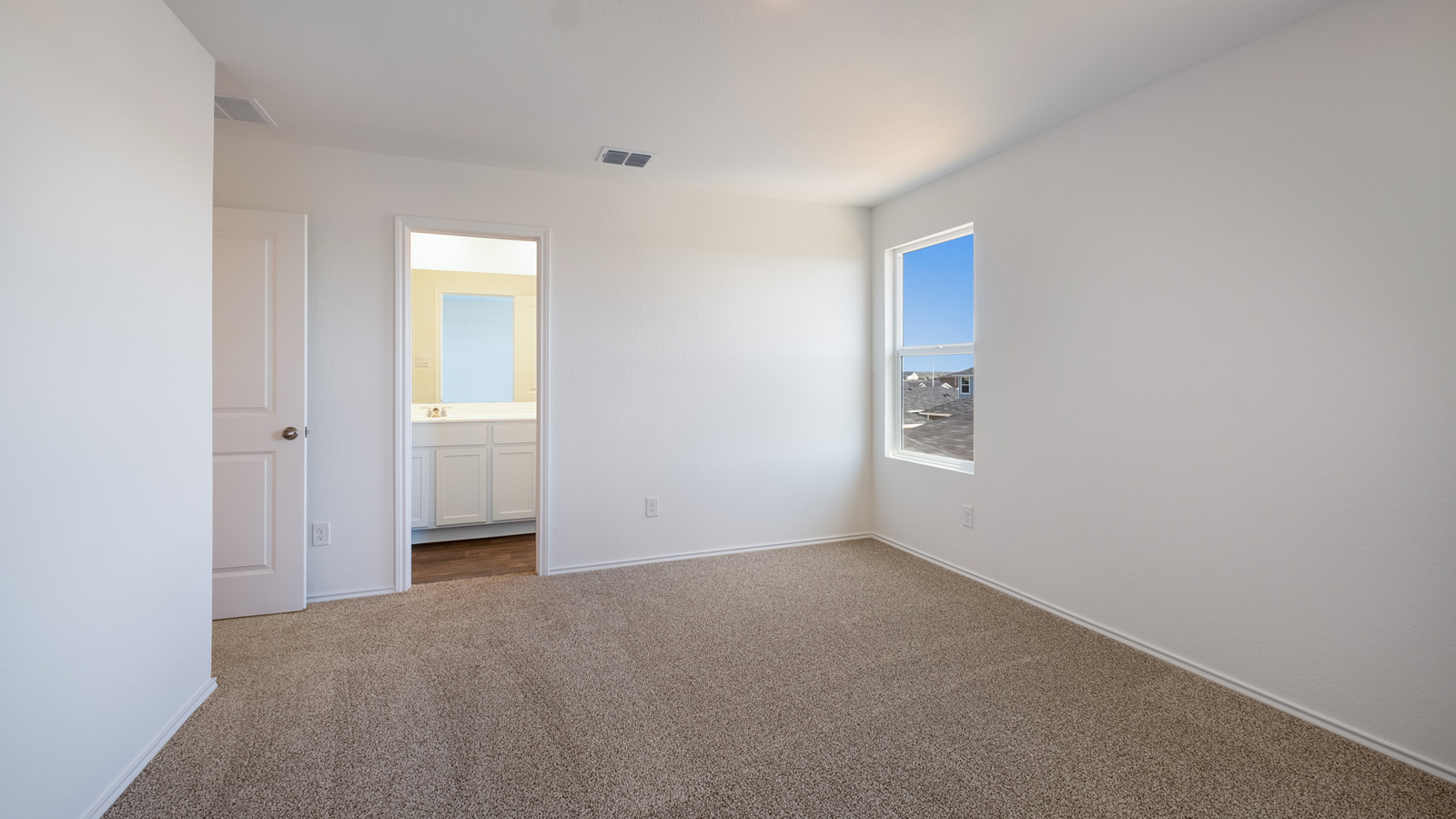 Primary bedroom designed for privacy and space with a convenient flow into spa-inspired ensuite bathroom and walk-in closet