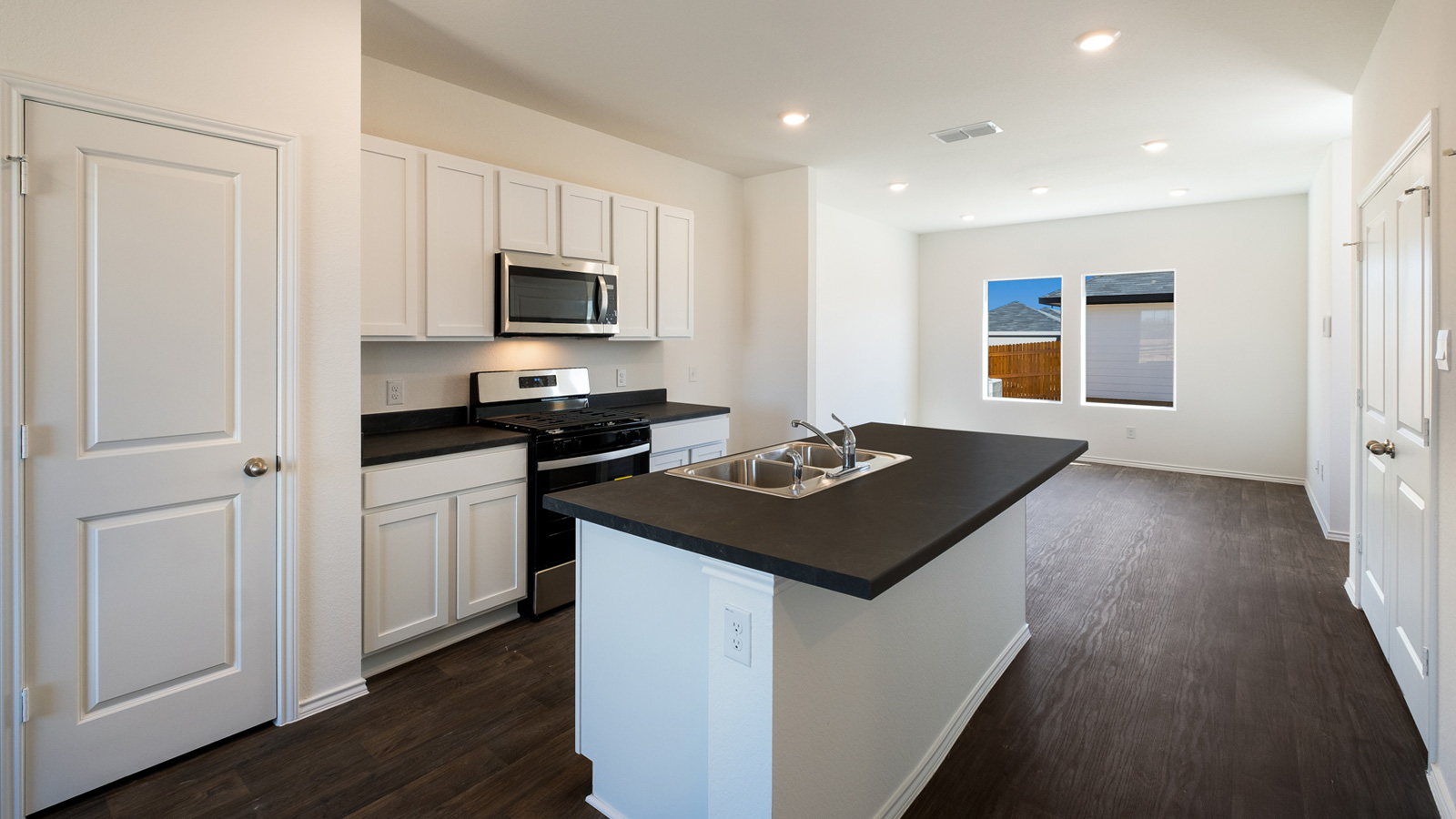 Central kitchen island adds a sink, seating, designed to anchor the home, pantry, prep zones, perfect for entertaining, everyday life