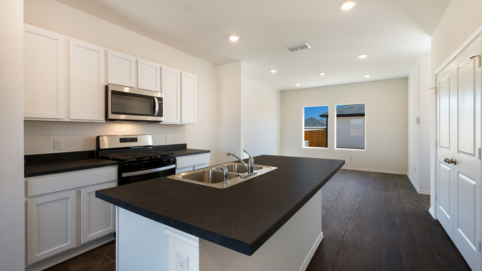 New appliances included, and a larger kitchen island, a sink, seating anchor our kitchen, pantry, near dining, living rooms