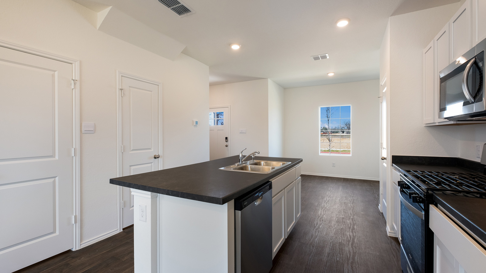 Spacious Kitchen island in this new home with sink, dining areas, daily prep zones, for entertaining and daily life
