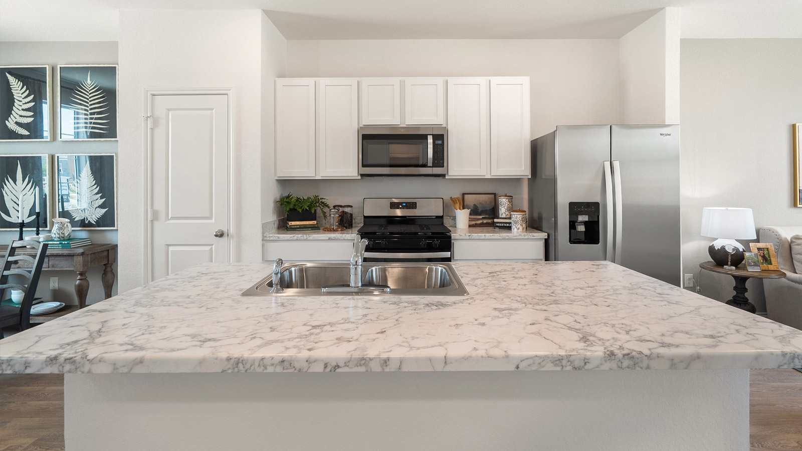 Interior kitchen with white cabinets and large central island