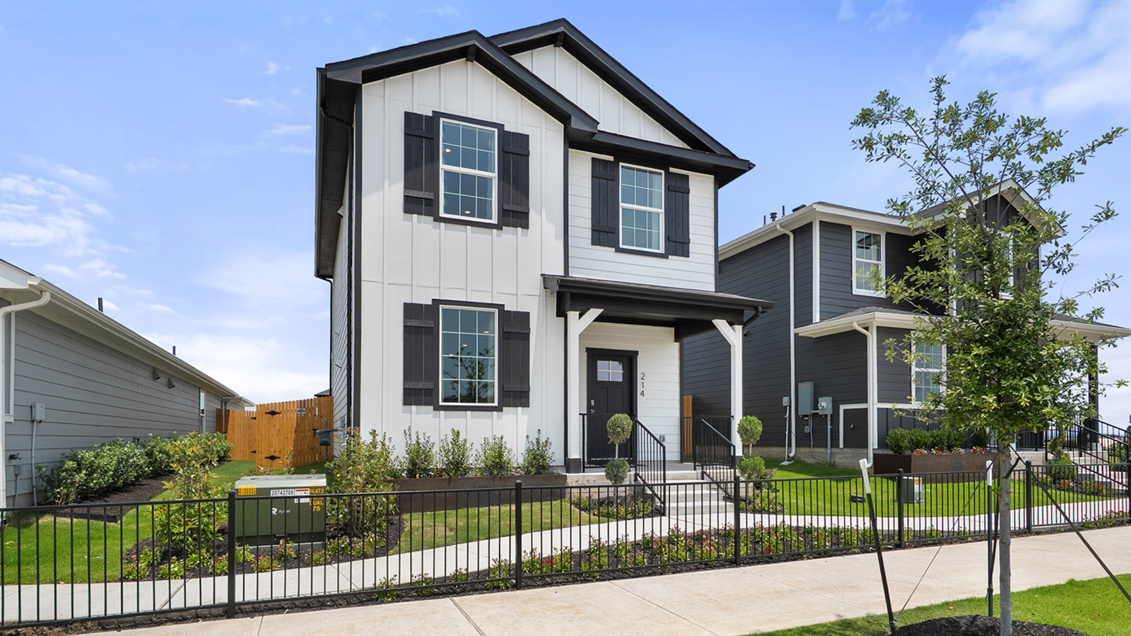 Exterior of two story home with white wood cladding