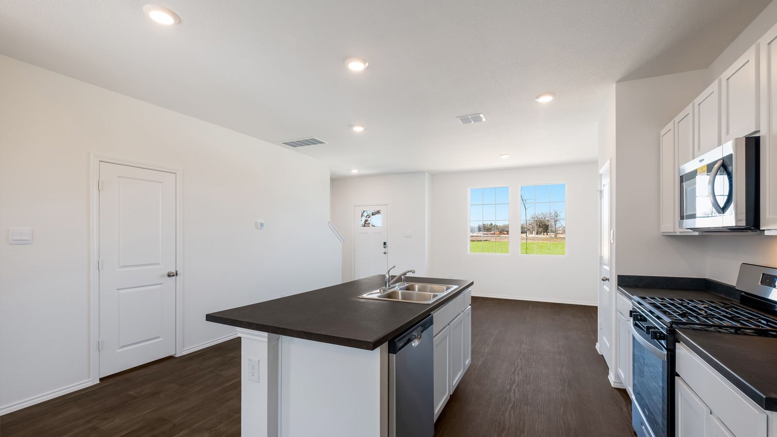 kitchen with white cabinetry, large island, and stainless steel appliances