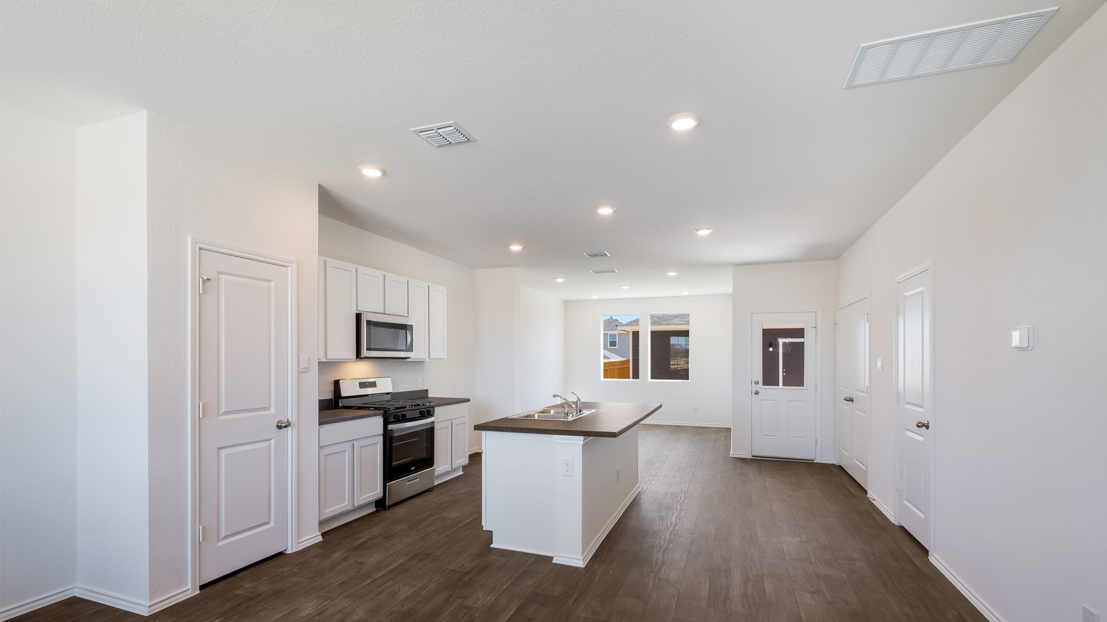 Open concept first floor with the living room, dining room and kitchen next to each other