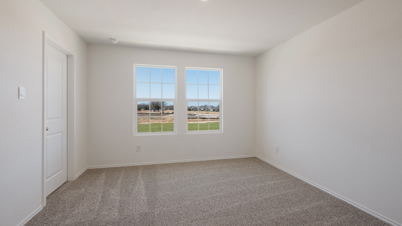 Main bedroom with carpeted floors.