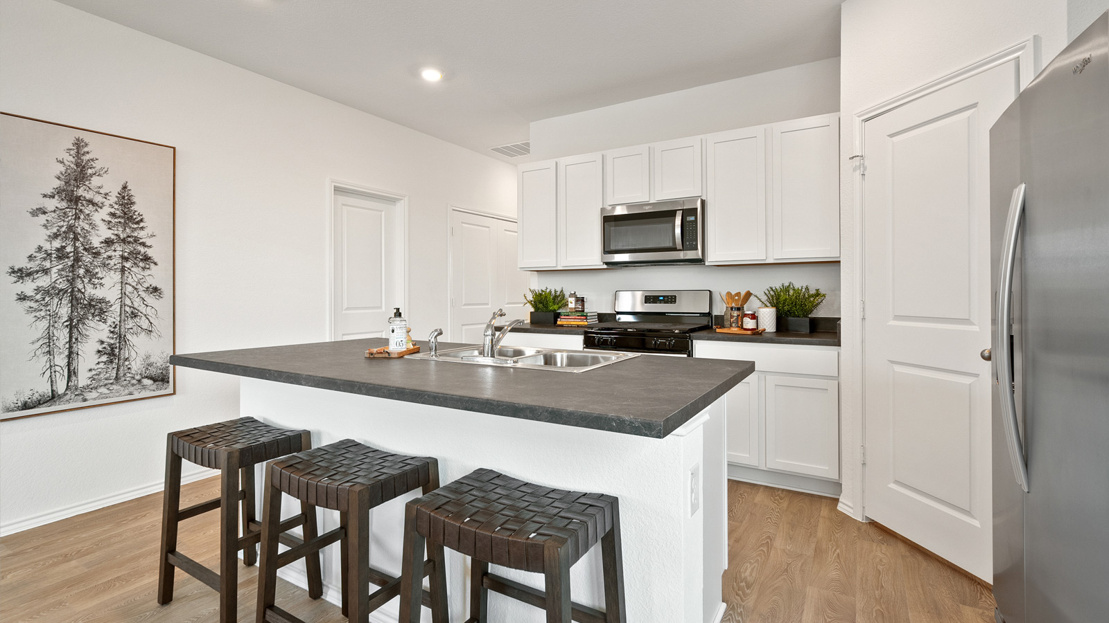 Interior kitchen with white cabinets and large central island