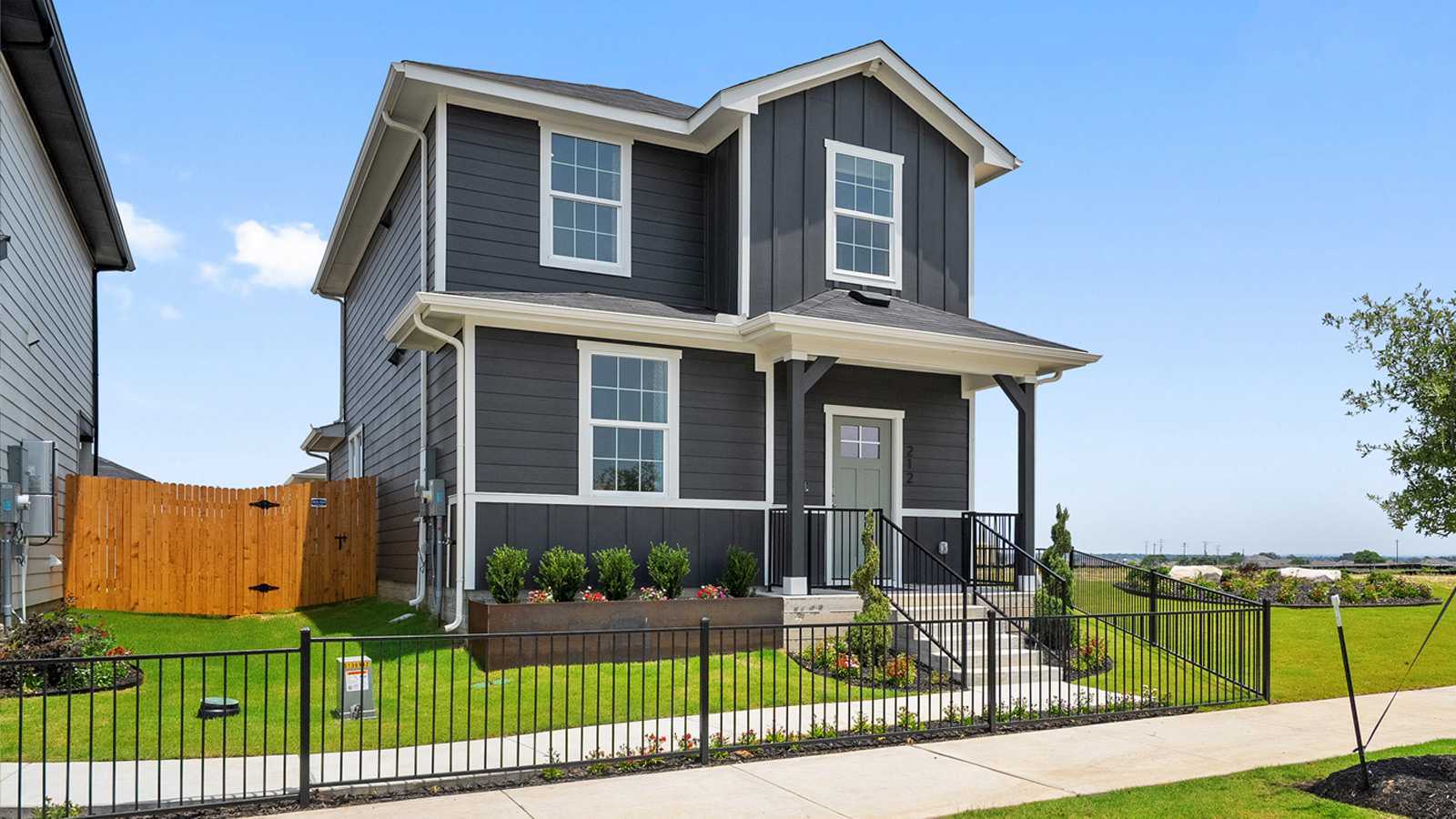 Exterior of two story home with grey wood cladding