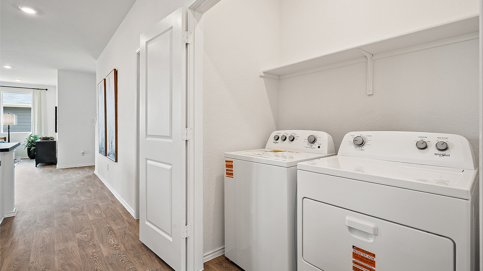 Interior of hall way with doors open to show laundry area