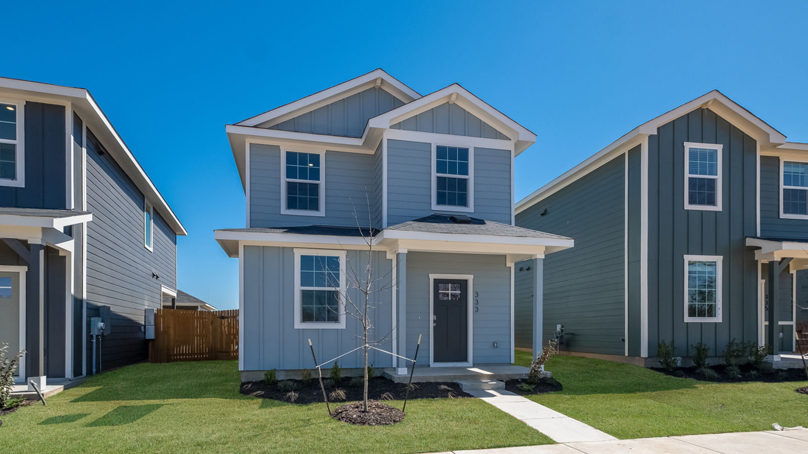 Exterior of two story home with blue wood cladding