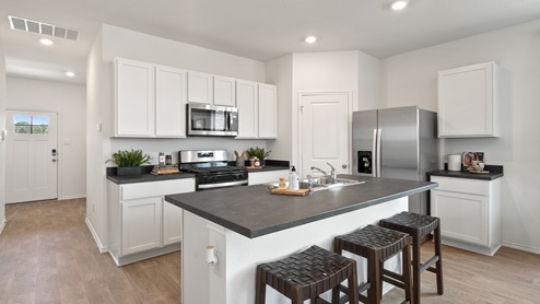 Interior of kitchen with white cabinets and central island