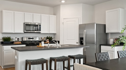 Interior of kitchen with white cabinets and central island