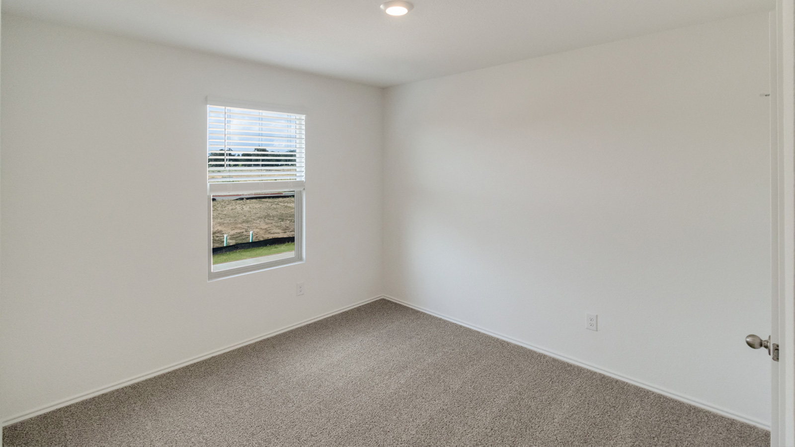 Bedroom 3 with carpeted flooring.