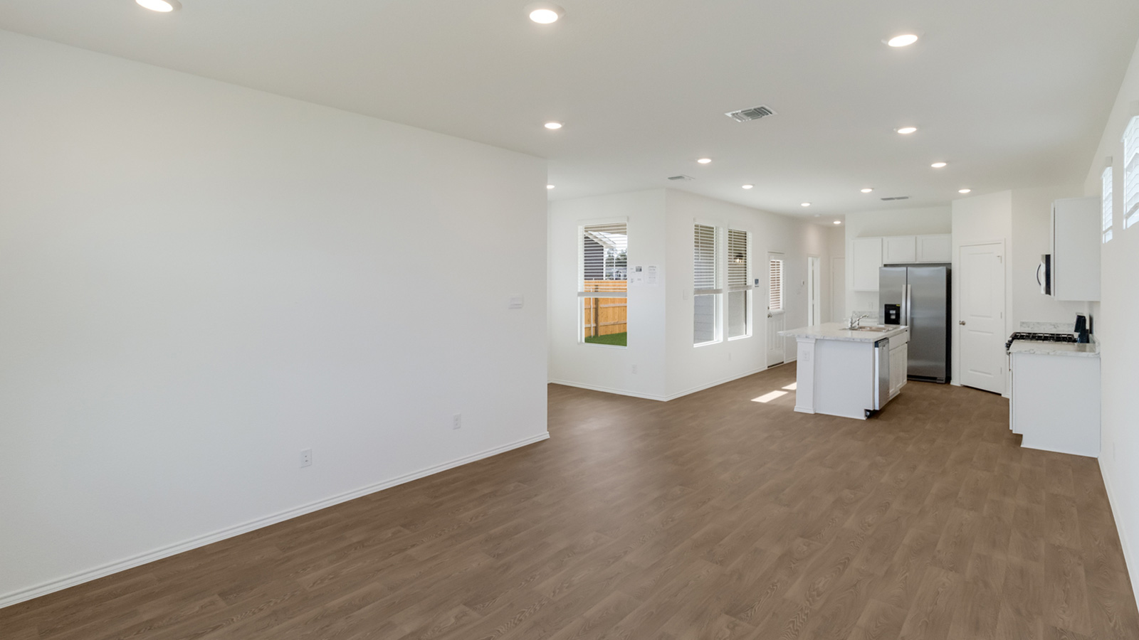 Gourmet kitchen with laminated wood flooring.