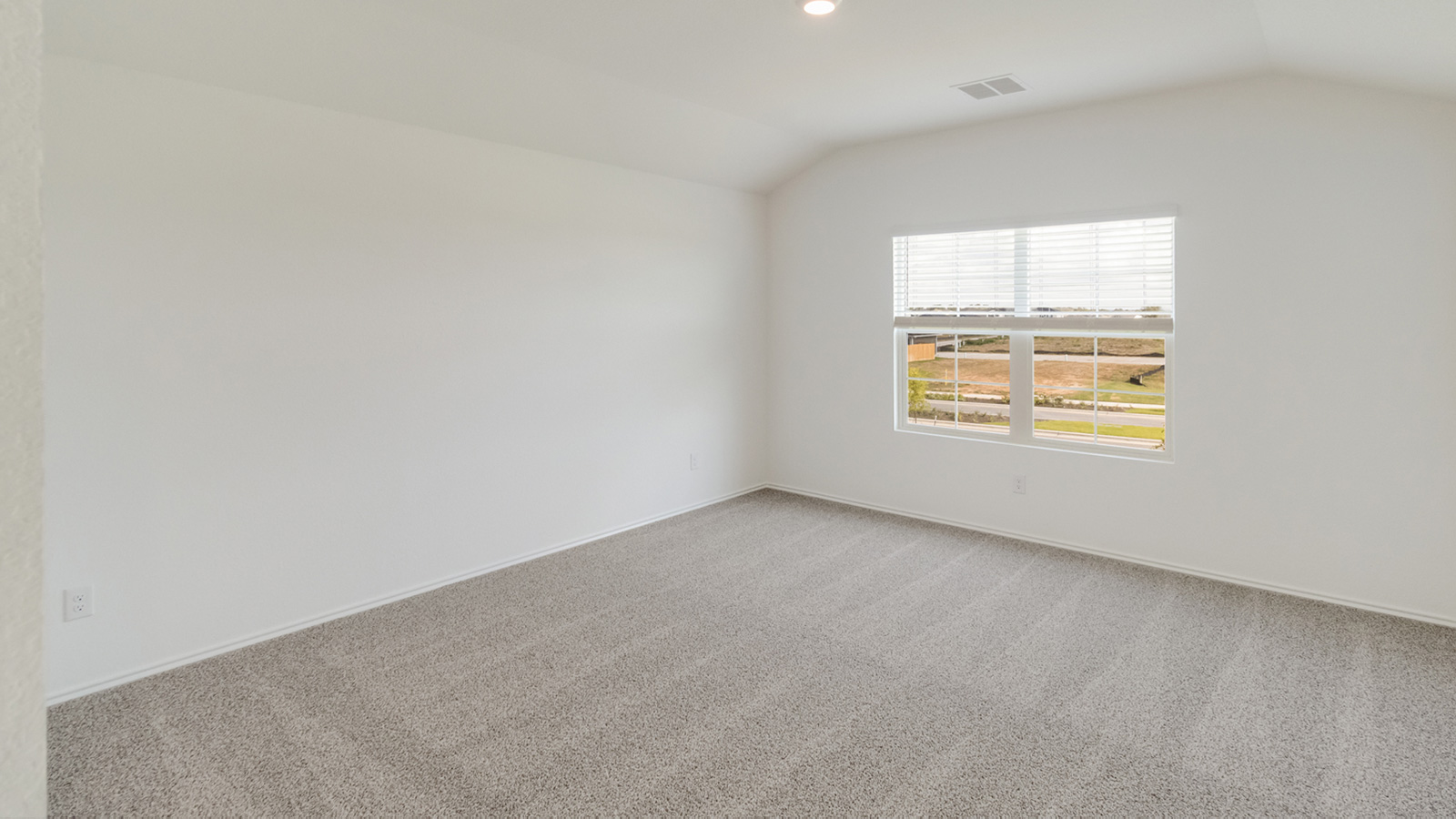 Bedroom 1 with carpeted flooring.