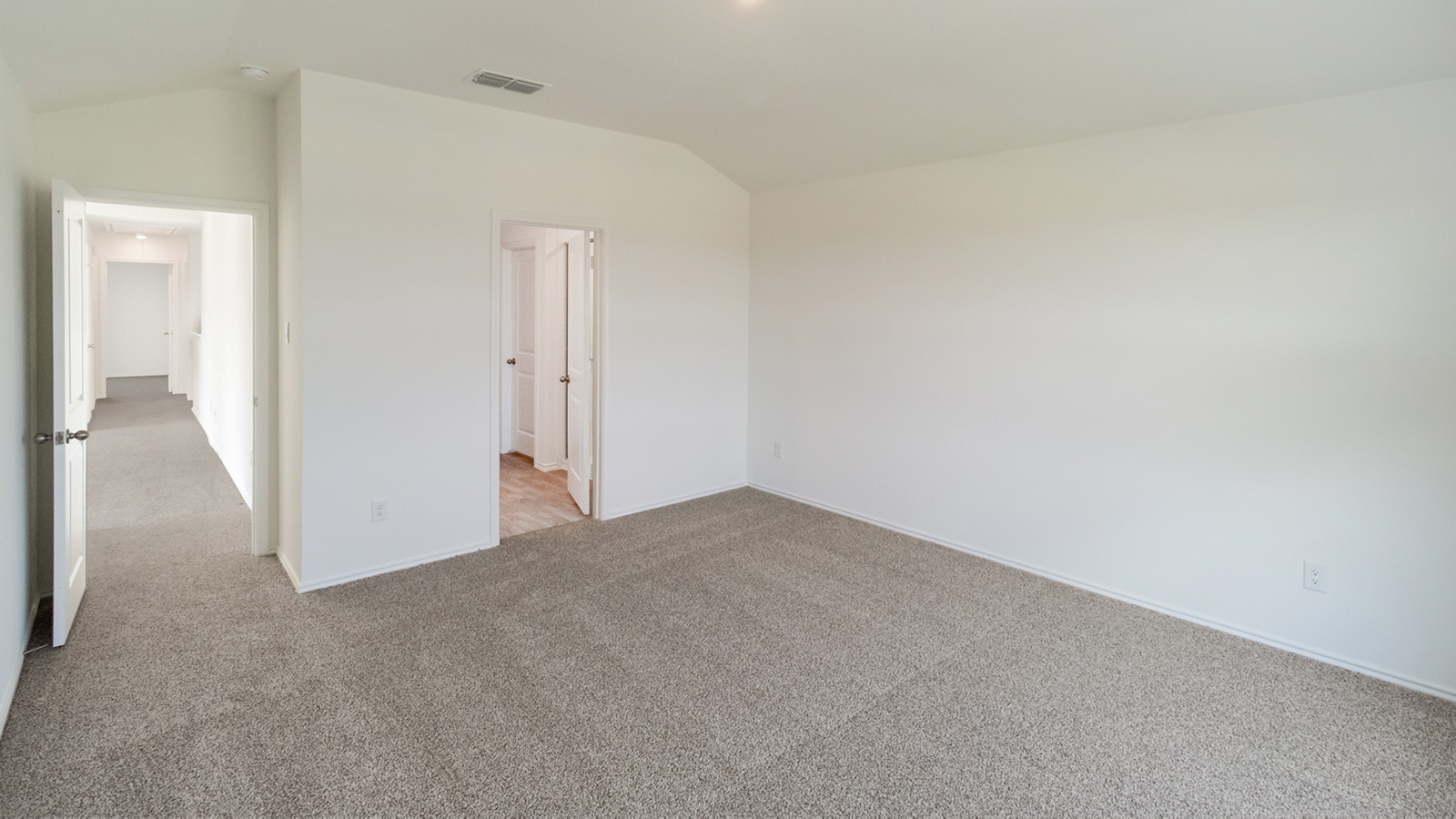 Bedroom 1 with carpeted flooring.
