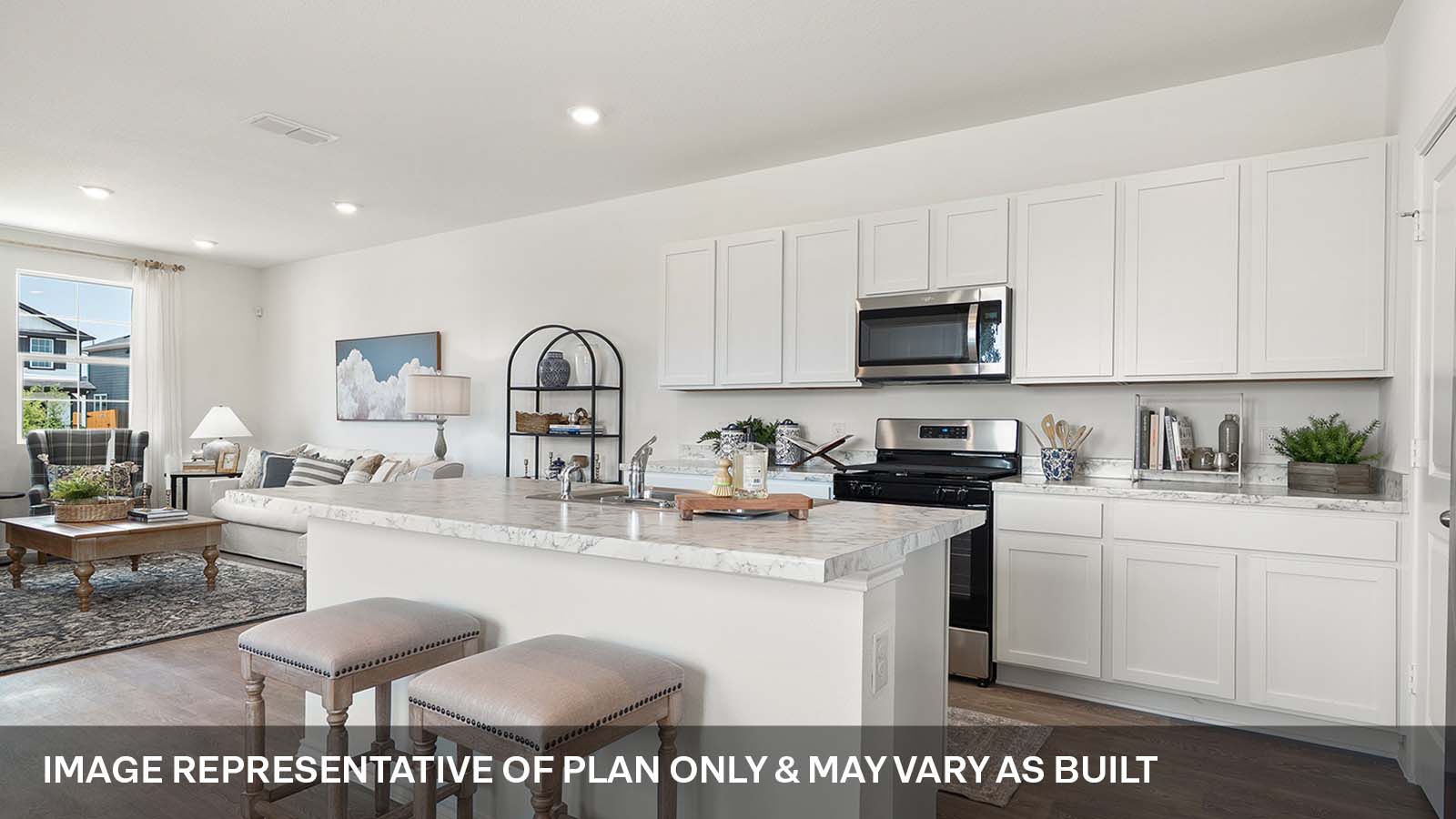 Modern kitchen with stainless steel range and microwave.