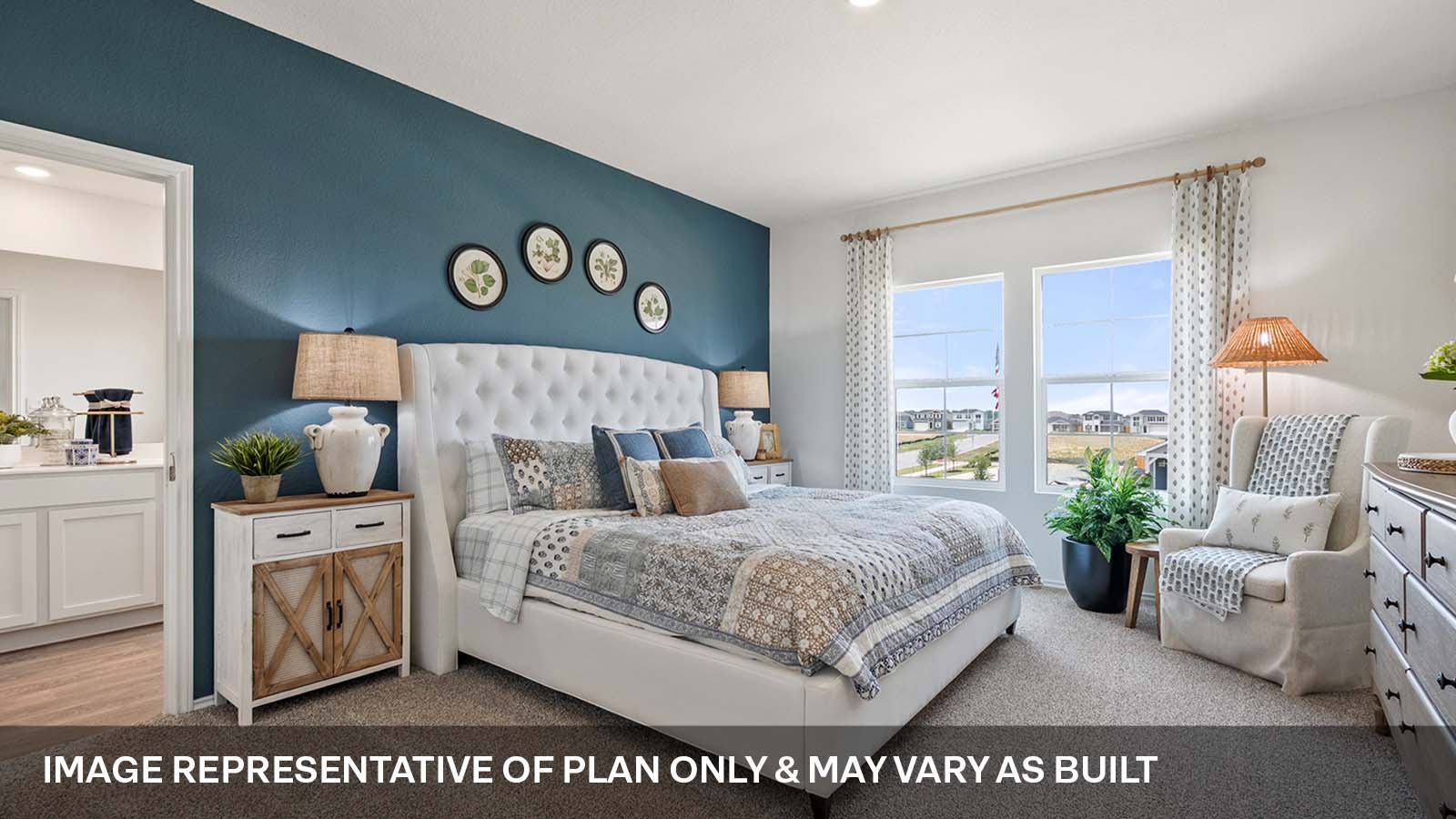 Primary bedroom with large windows and carpeted flooiring.