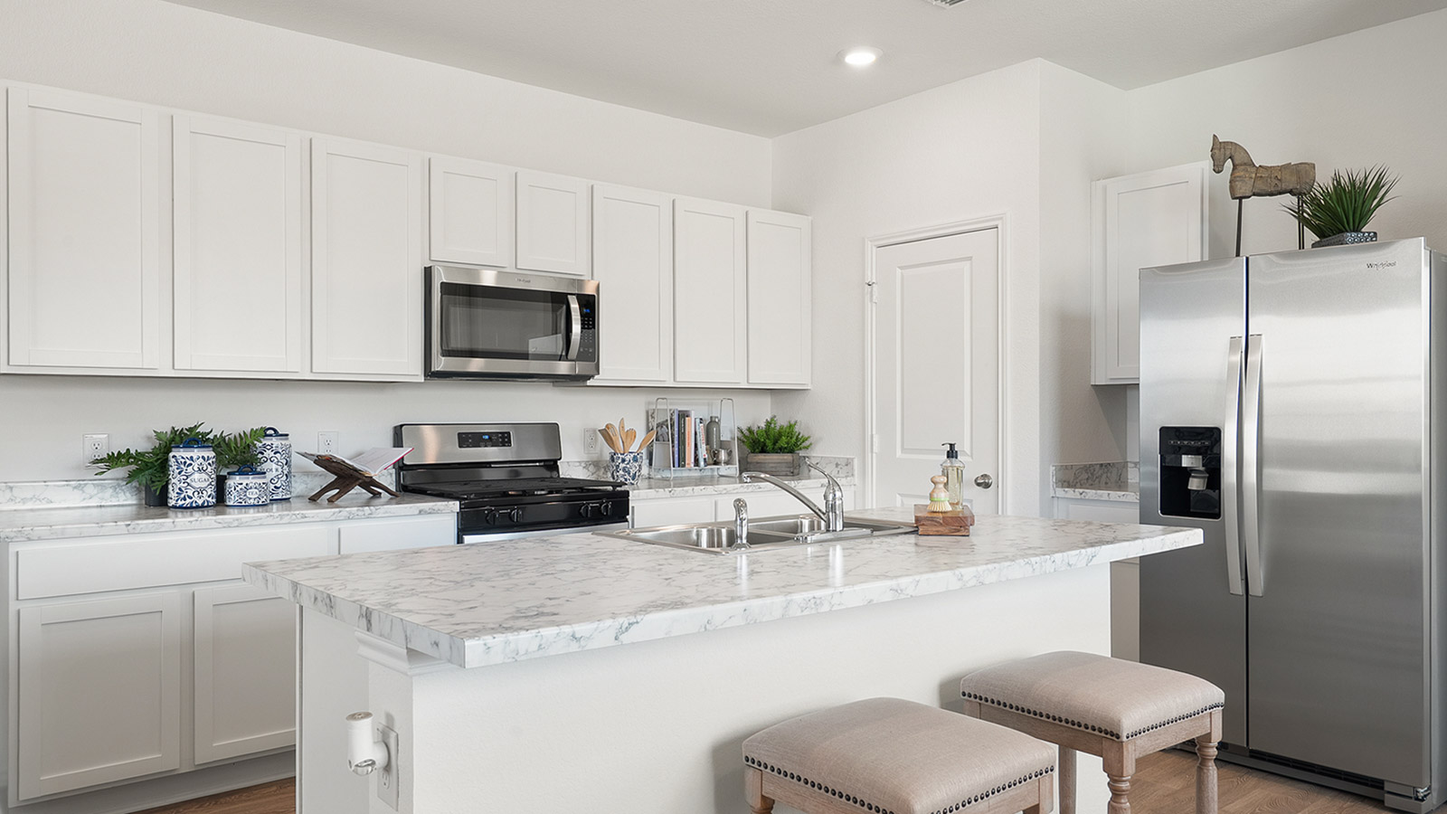 Interior kitchen with white cabinets and large central island