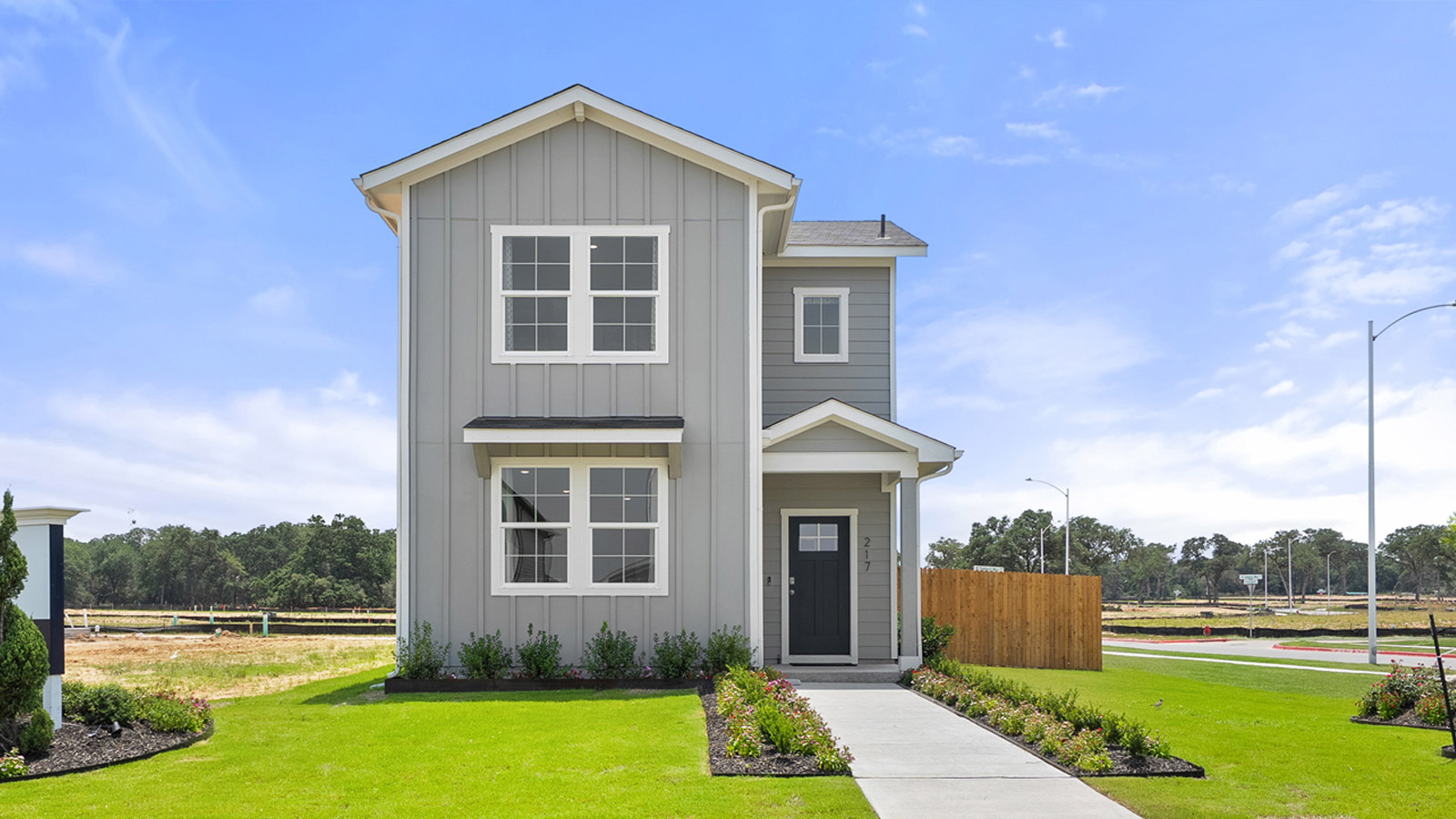 Exterior of two story home with grey wood cladding