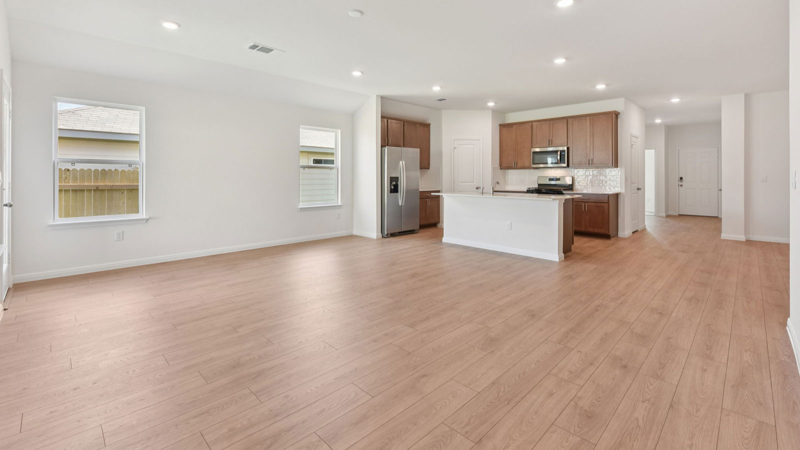 Open living area with premium laminate wood plank flooring.