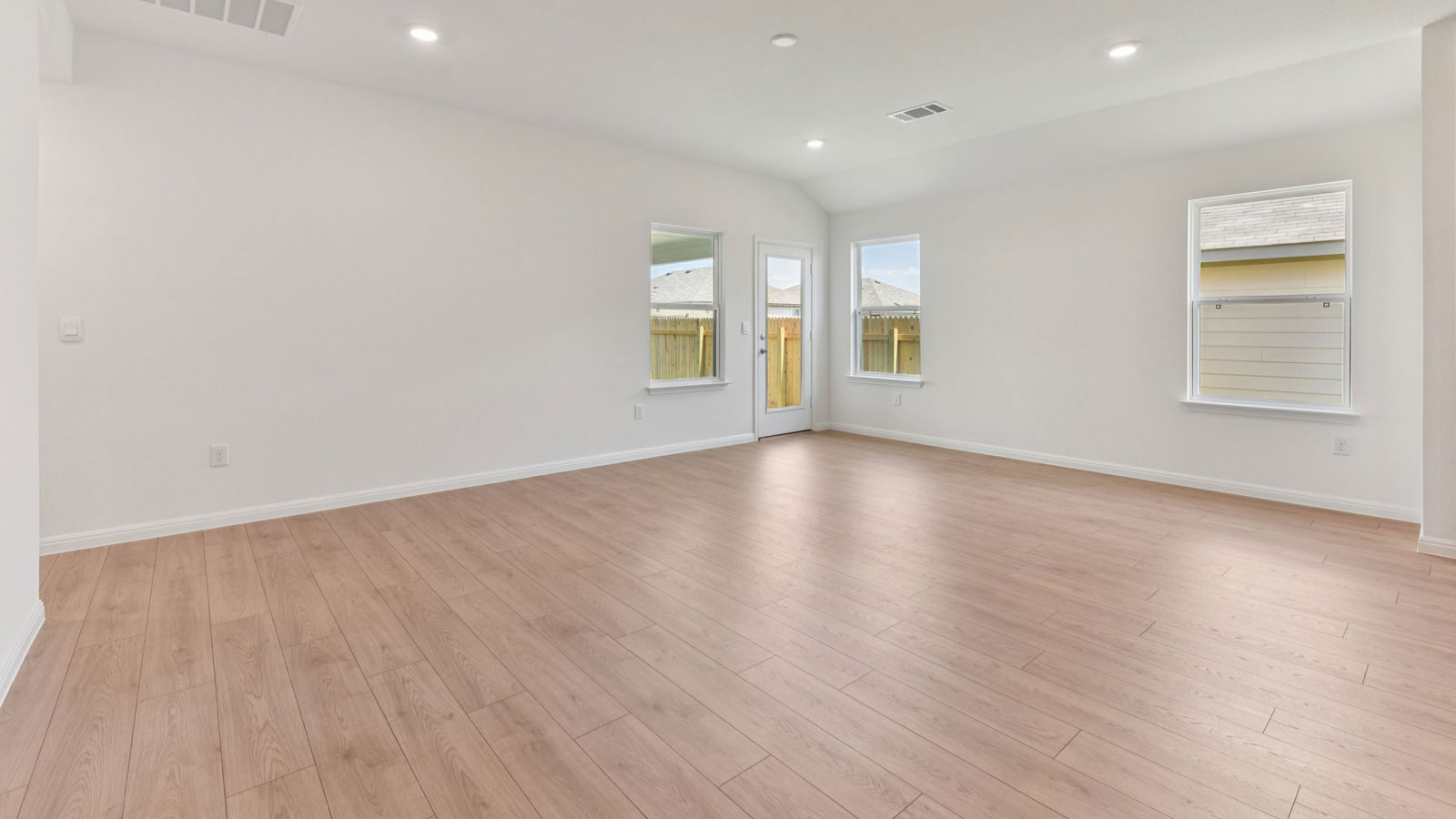 Open living area with premium laminate wood plank flooring.