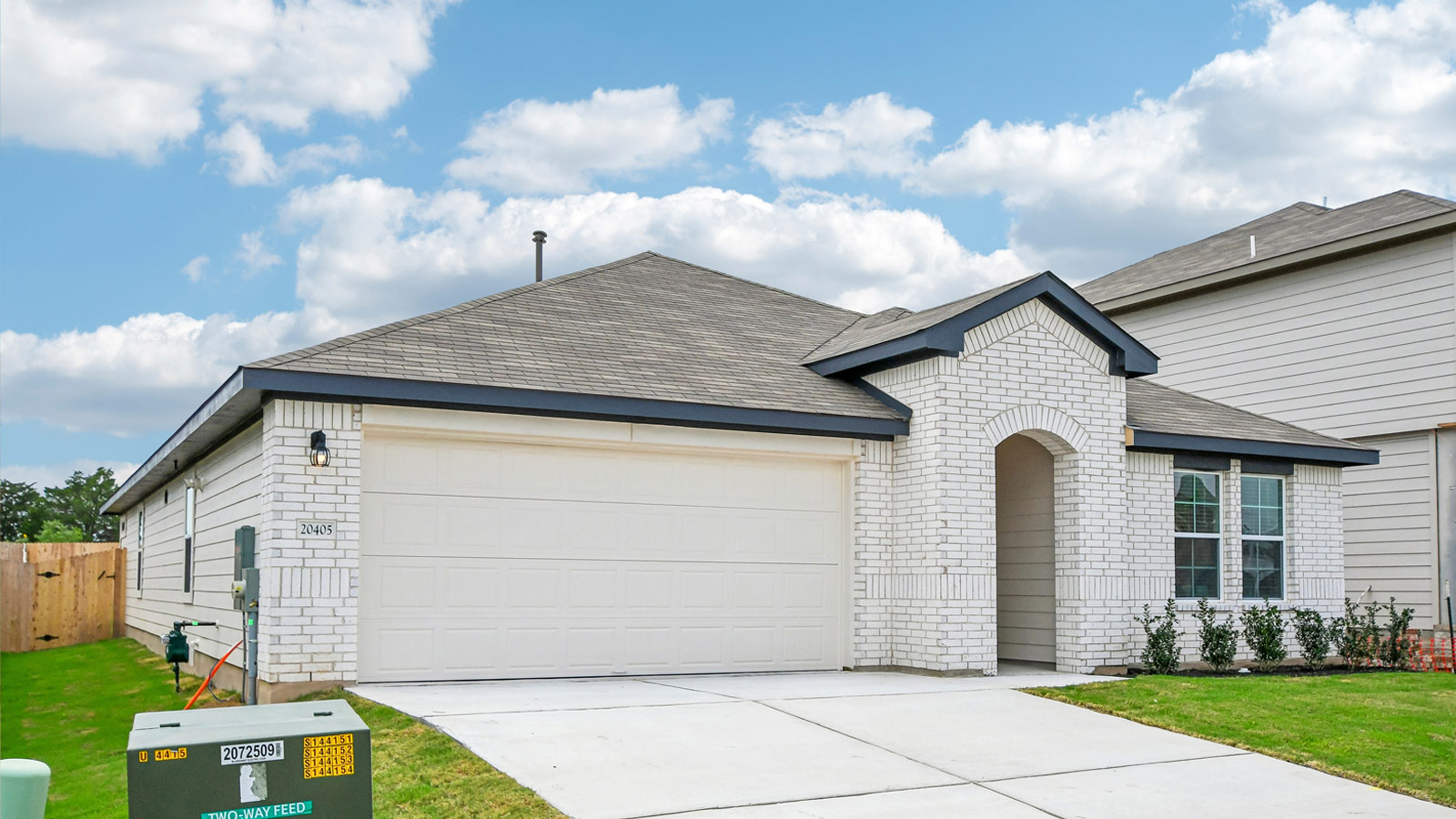 Exterior shot of 20405 Tuberville Lane at Carillon in Manor, TX - The Lakeway floorplan.